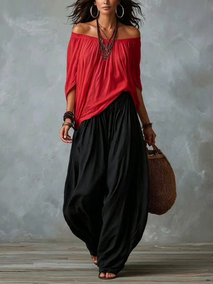 Blusa blanca con hombros descubiertos y pantalones de corte ancho estilo linterna