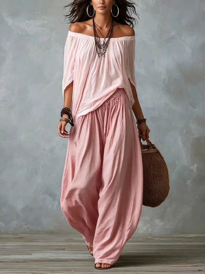 Blusa blanca con hombros descubiertos y pantalones de corte ancho estilo linterna