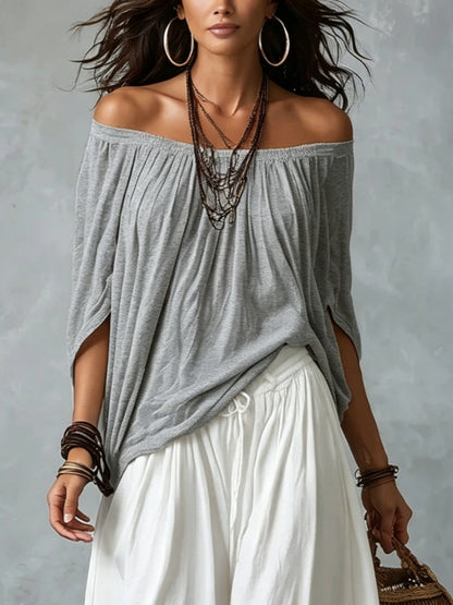 Blusa blanca con hombros descubiertos y pantalones de corte ancho estilo linterna