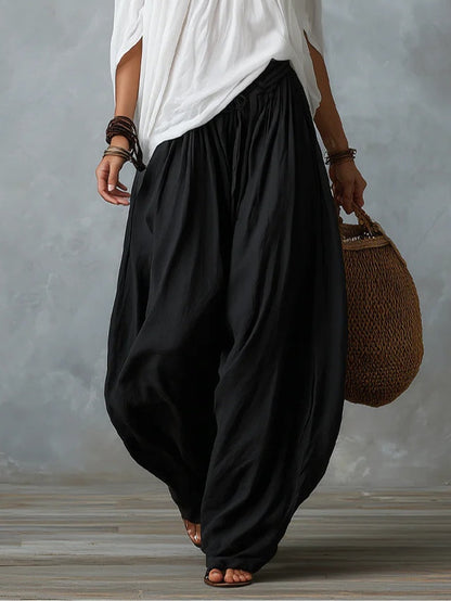 Blusa blanca con hombros descubiertos y pantalones de corte ancho estilo linterna