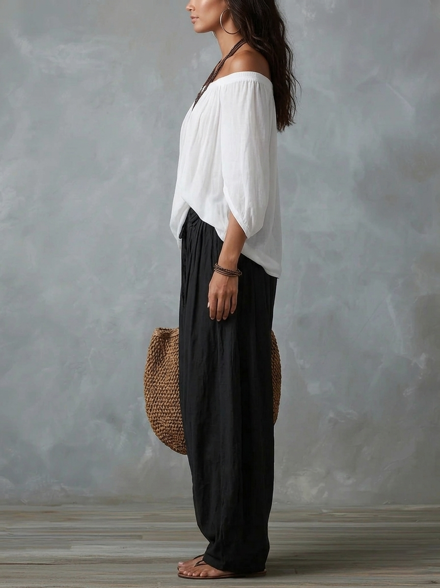 Blusa blanca con hombros descubiertos y pantalones de corte ancho estilo linterna