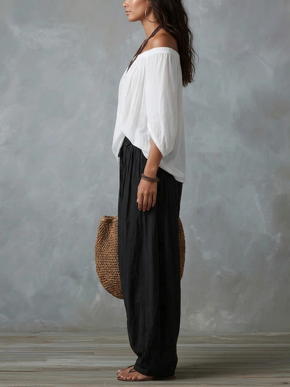 Blusa blanca con hombros descubiertos y pantalones de corte ancho estilo linterna