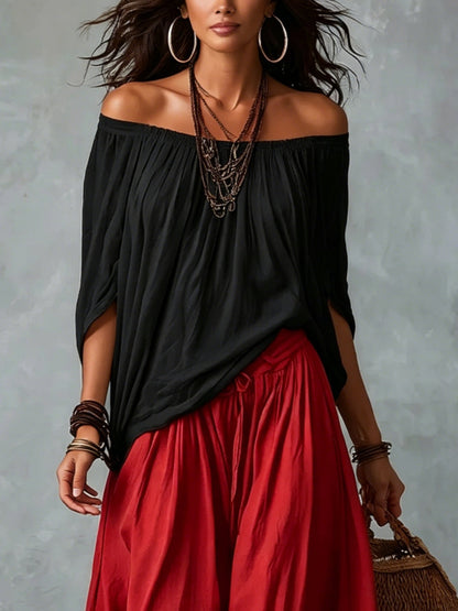 Blusa blanca con hombros descubiertos y pantalones de corte ancho estilo linterna