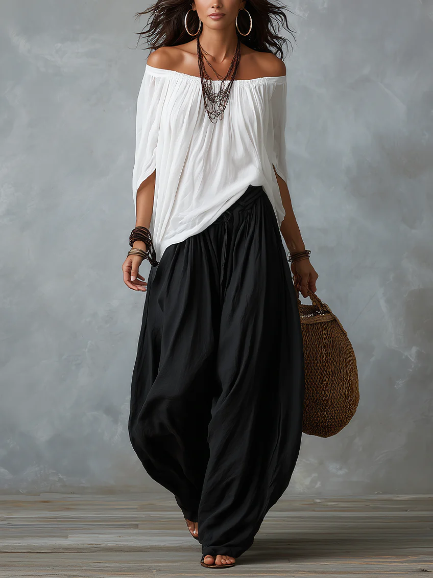 Blusa blanca con hombros descubiertos y pantalones de corte ancho estilo linterna