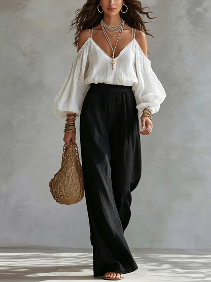Conjunto de blusa blanca sin mangas y pantalones negros de pierna ancha